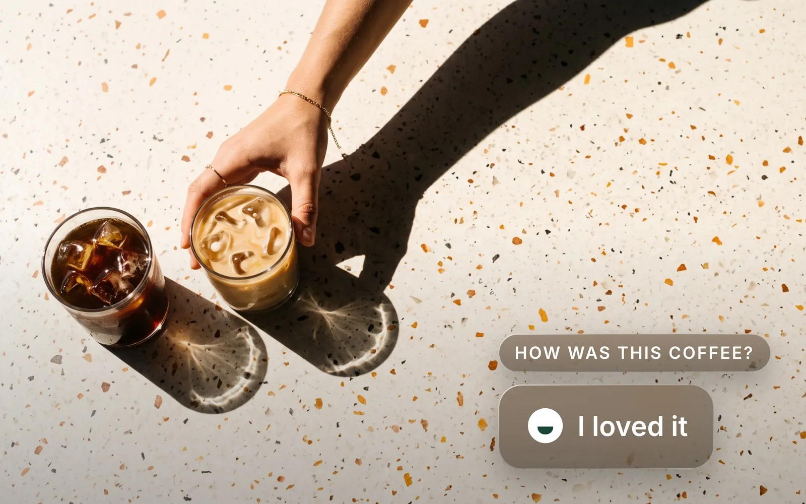 Two iced coffees on a terrazzo table, with the Siip question How was this coffee? answered I loved it